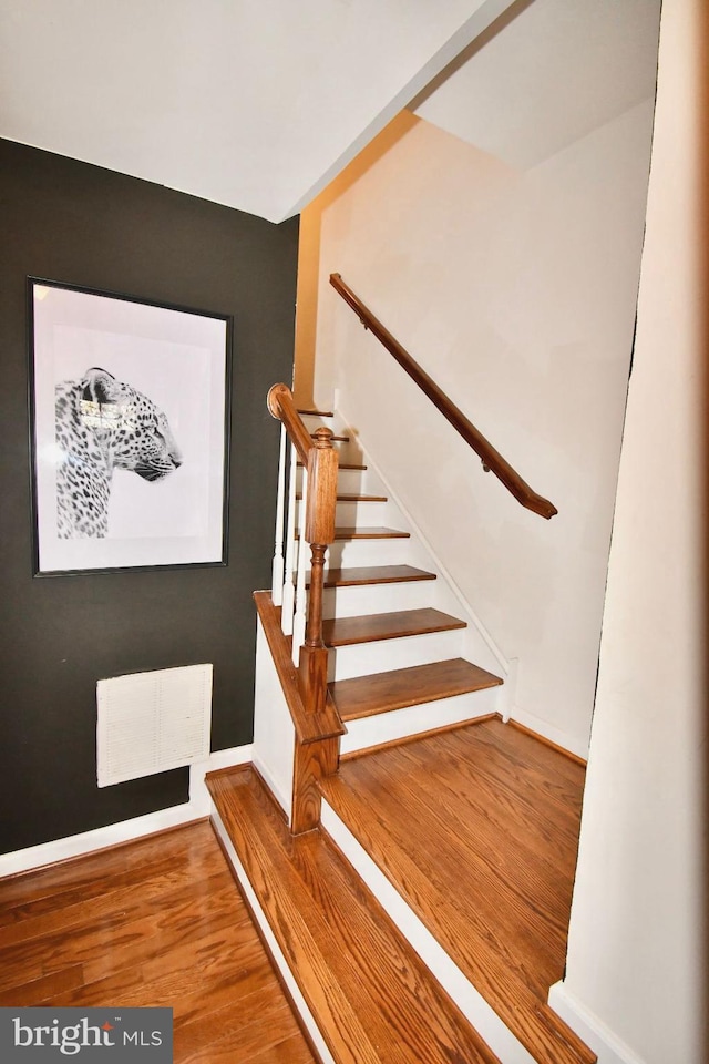 stairs with wood-type flooring