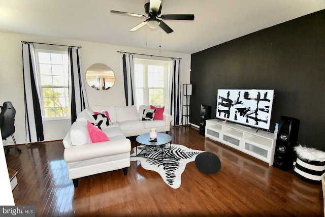 living room with a healthy amount of sunlight, dark wood-type flooring, and ceiling fan