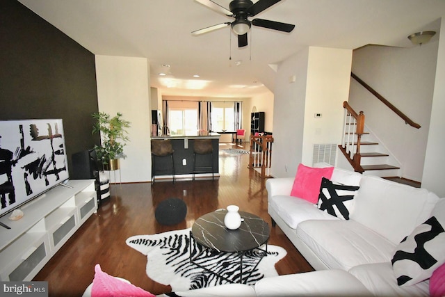 living room featuring dark hardwood / wood-style floors and ceiling fan