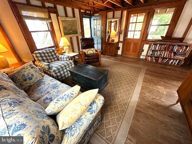 living room featuring a wealth of natural light and dark hardwood / wood-style floors