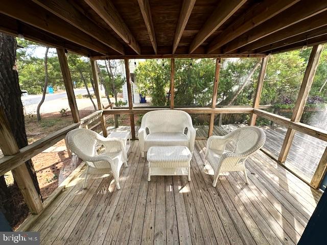 sunroom featuring beamed ceiling