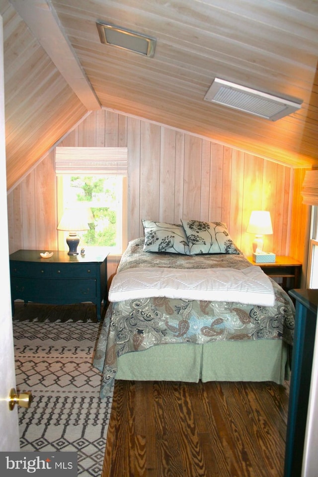 bedroom with vaulted ceiling with beams, wooden walls, and wood ceiling