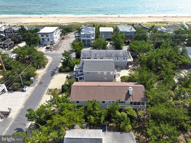 drone / aerial view with a beach view and a water view