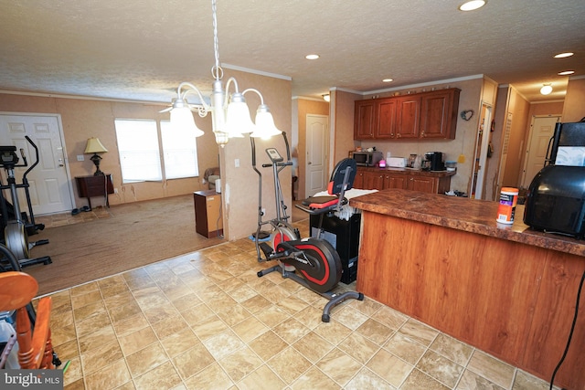 kitchen with light colored carpet, an inviting chandelier, hanging light fixtures, and a textured ceiling