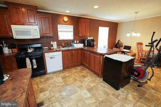 kitchen with an inviting chandelier, white appliances, decorative light fixtures, and crown molding