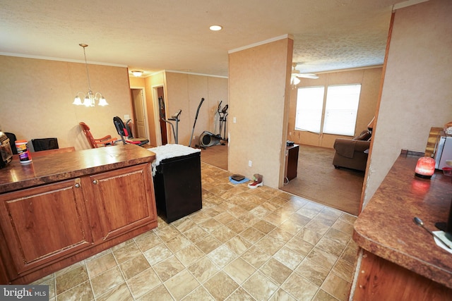 kitchen featuring a textured ceiling, ceiling fan with notable chandelier, light colored carpet, decorative light fixtures, and ornamental molding