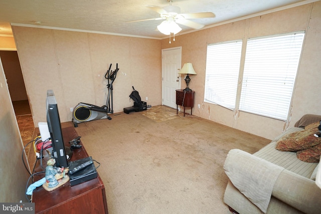 interior space featuring ornamental molding, ceiling fan, and carpet flooring