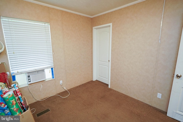 spare room featuring cooling unit, a textured ceiling, crown molding, and carpet flooring