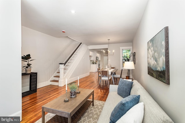 living room with hardwood / wood-style flooring and a chandelier