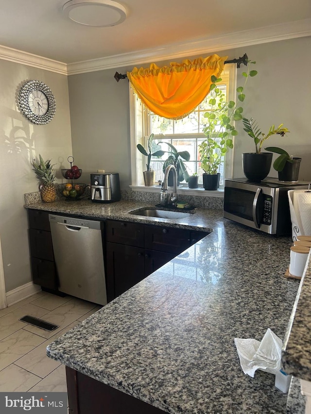 kitchen featuring crown molding, appliances with stainless steel finishes, and sink