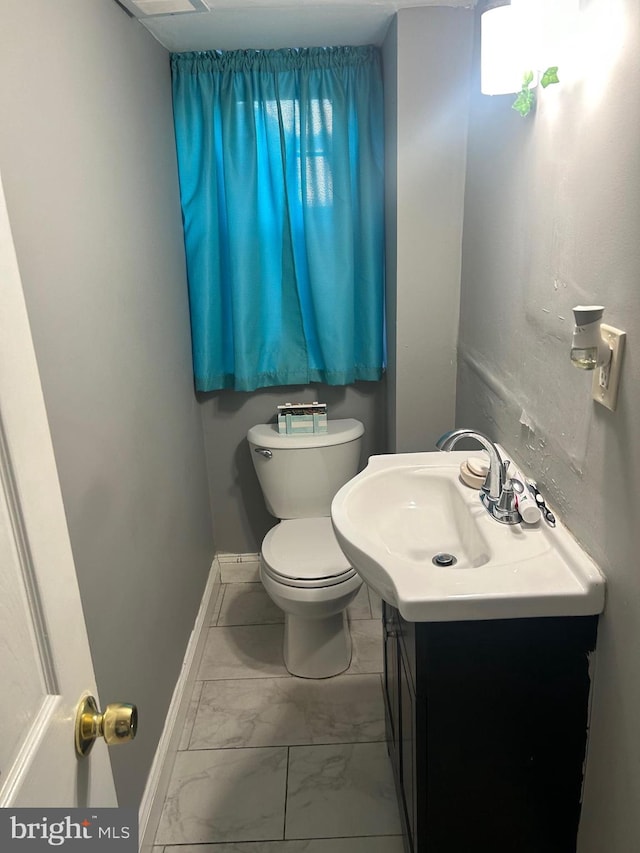 bathroom featuring vanity and toilet