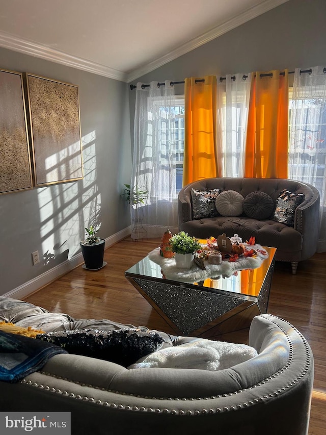 living room with ornamental molding, lofted ceiling, and hardwood / wood-style floors