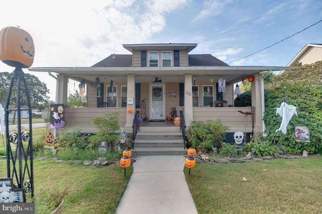 bungalow-style house with a porch and a front lawn