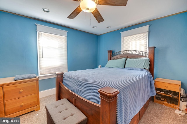 bedroom with ceiling fan and light colored carpet