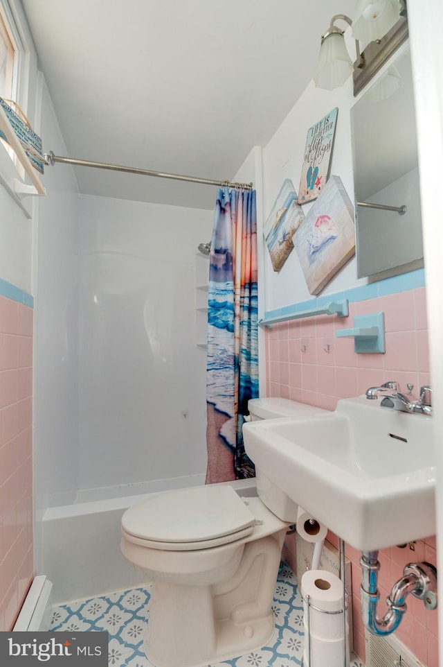 bathroom with tile walls, tile patterned flooring, and toilet