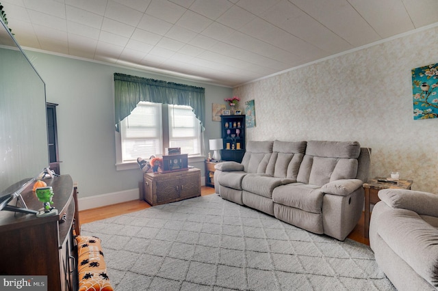 living room with light hardwood / wood-style flooring and crown molding