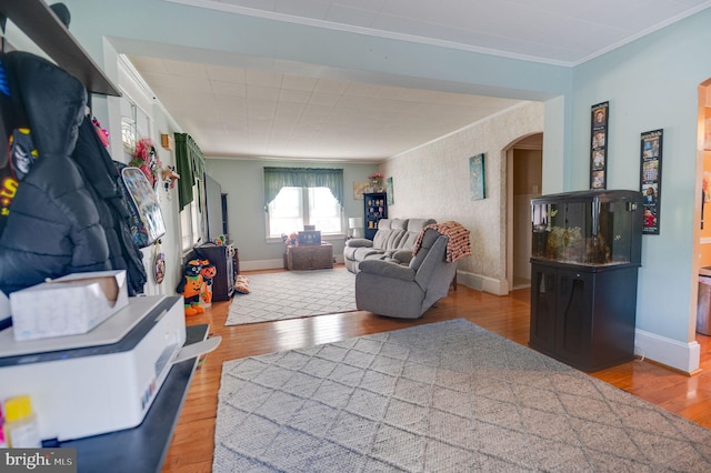 living room with hardwood / wood-style floors and crown molding