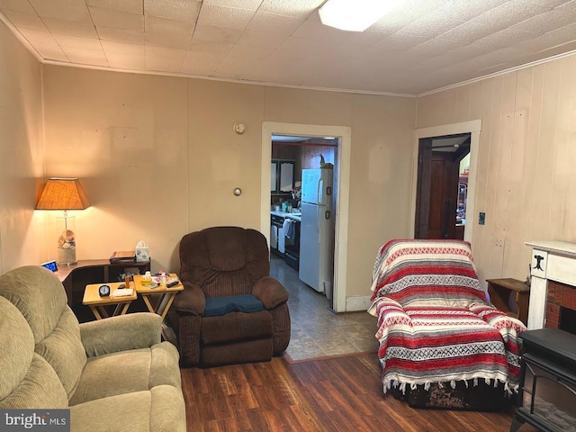 living room with dark hardwood / wood-style flooring and ornamental molding