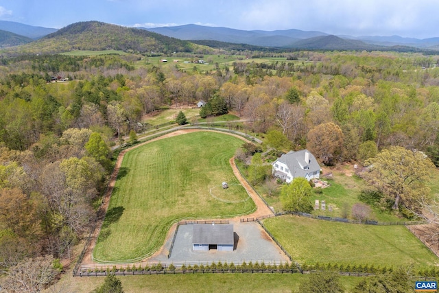 drone / aerial view with a rural view, a wooded view, and a mountain view