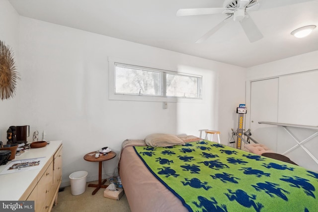 bedroom with ceiling fan, a closet, and light colored carpet