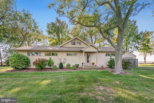 ranch-style house with a front lawn