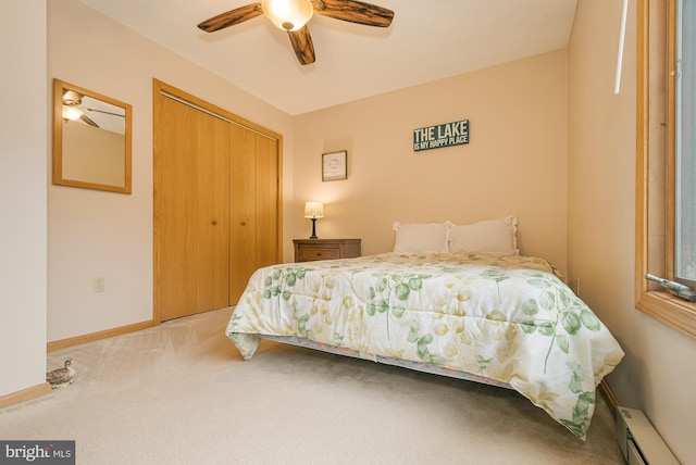 bedroom featuring a baseboard radiator, a closet, light colored carpet, and ceiling fan