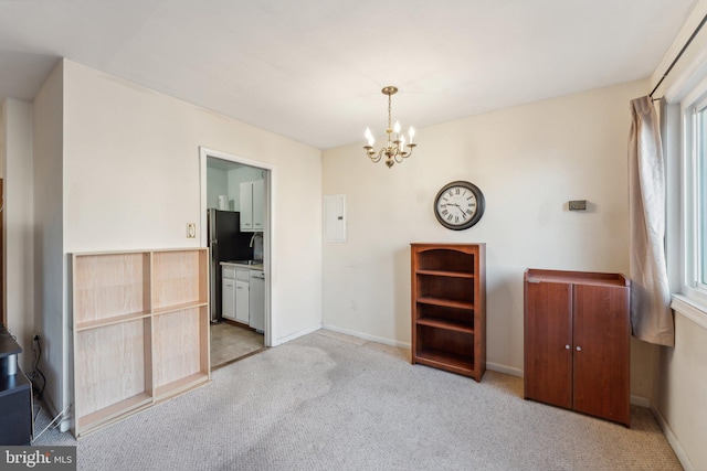 empty room featuring light carpet, a wealth of natural light, and an inviting chandelier