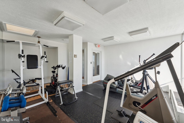 workout area featuring a textured ceiling