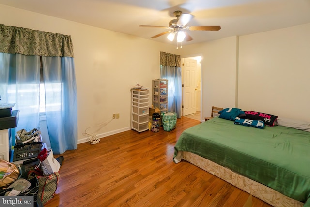 bedroom with wood-type flooring and ceiling fan