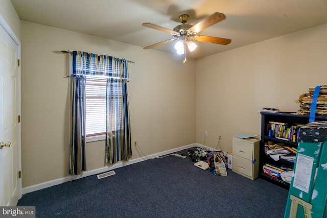 recreation room with dark colored carpet and ceiling fan