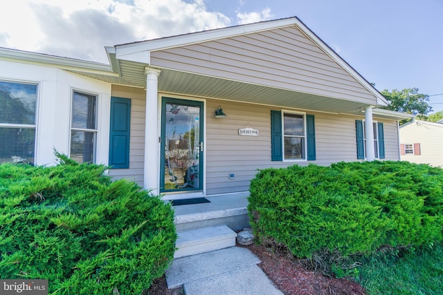 property entrance with covered porch