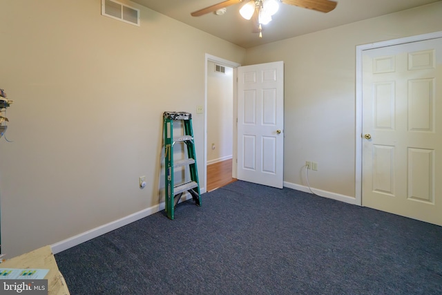 unfurnished bedroom featuring ceiling fan and dark colored carpet