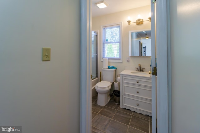 full bathroom featuring vanity, bath / shower combo with glass door, and toilet