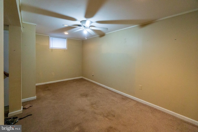 carpeted spare room with crown molding and ceiling fan