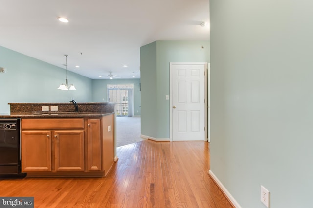 kitchen featuring sink, ceiling fan with notable chandelier, light hardwood / wood-style flooring, decorative light fixtures, and dishwasher