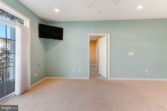 carpeted spare room with ceiling fan