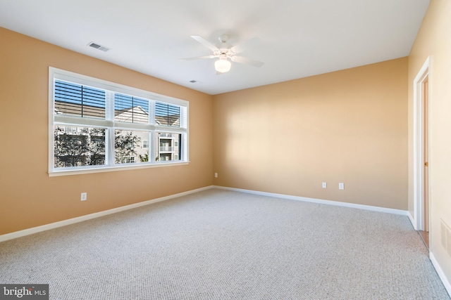 carpeted empty room featuring ceiling fan