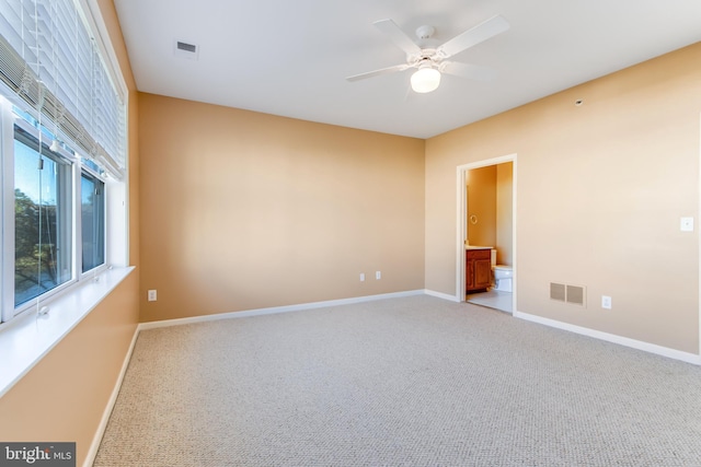 carpeted spare room with ceiling fan