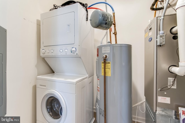 washroom with heating unit, stacked washer and dryer, and water heater