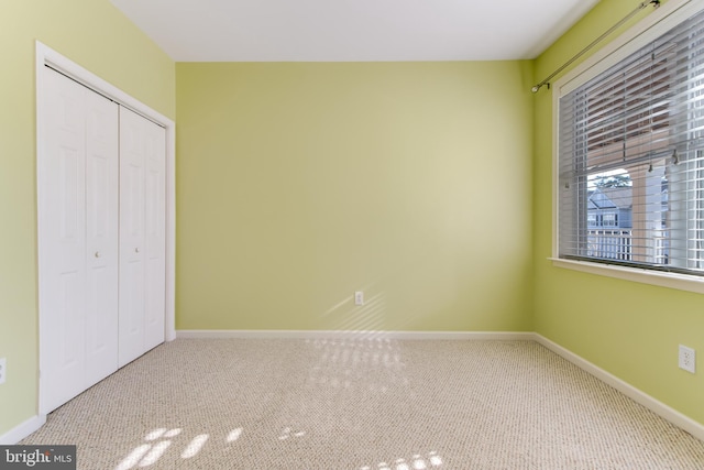 unfurnished bedroom with a closet and carpet