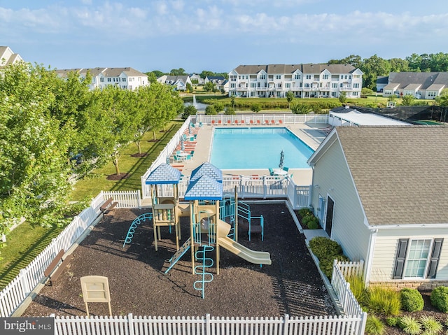 view of pool with a playground