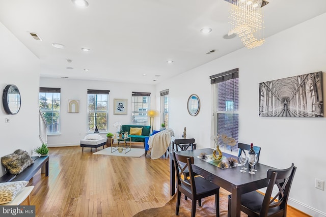 dining room featuring light hardwood / wood-style floors and an inviting chandelier