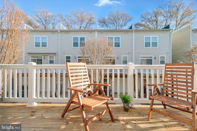 rear view of house featuring a wooden deck