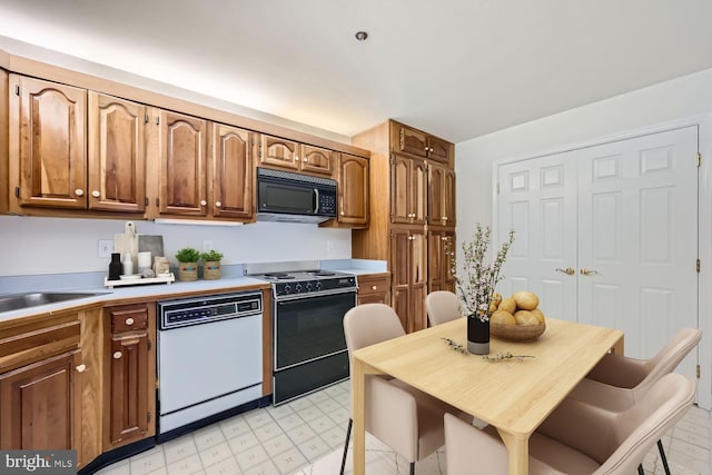 kitchen featuring stove, dishwasher, and sink