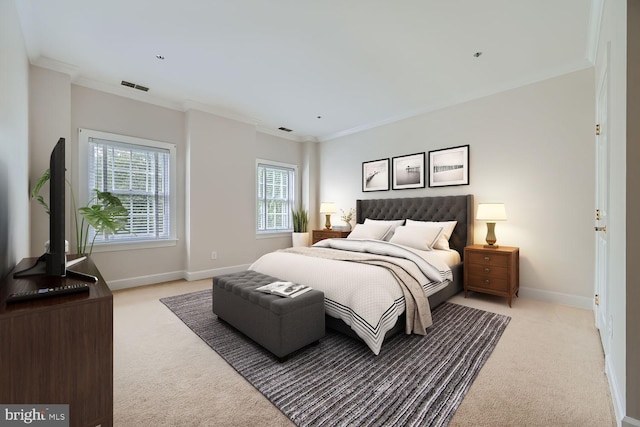 bedroom with crown molding and light carpet