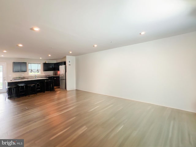 unfurnished living room with light hardwood / wood-style flooring