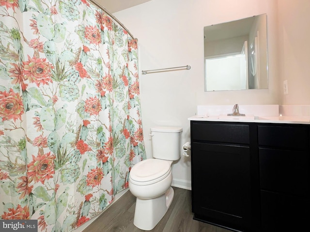 bathroom with a shower with shower curtain, vanity, toilet, and wood-type flooring