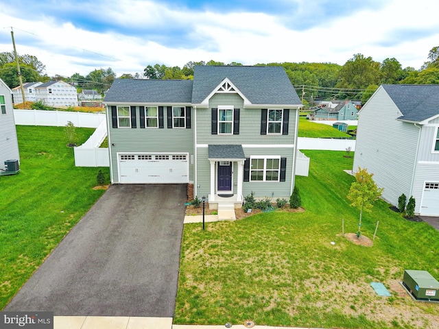 view of front of property featuring a garage and a front lawn