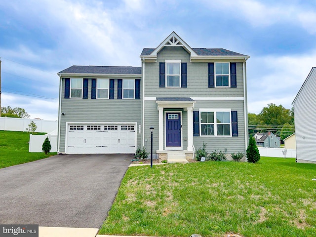 view of front of house with a front yard and a garage