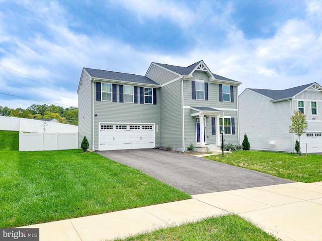 view of front of house featuring a garage and a front lawn